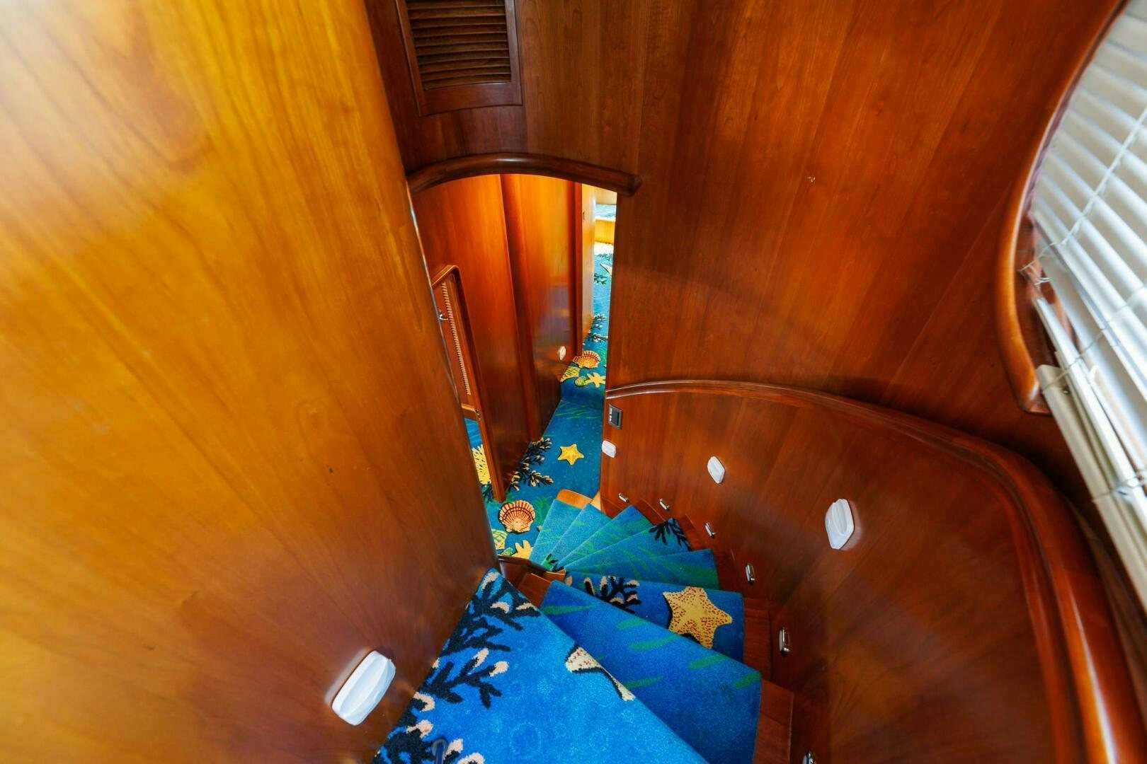 a blue toy train on a wooden surface aboard STRESS RELIEFF  Yacht for Sale