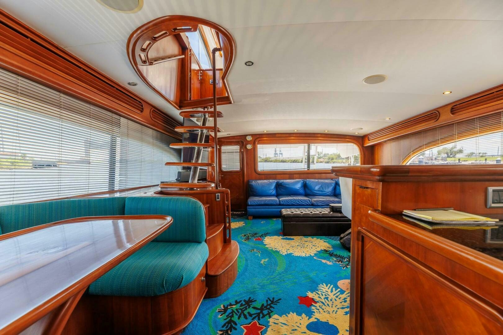 a bedroom with a blue rug aboard STRESS RELIEFF  Yacht for Sale
