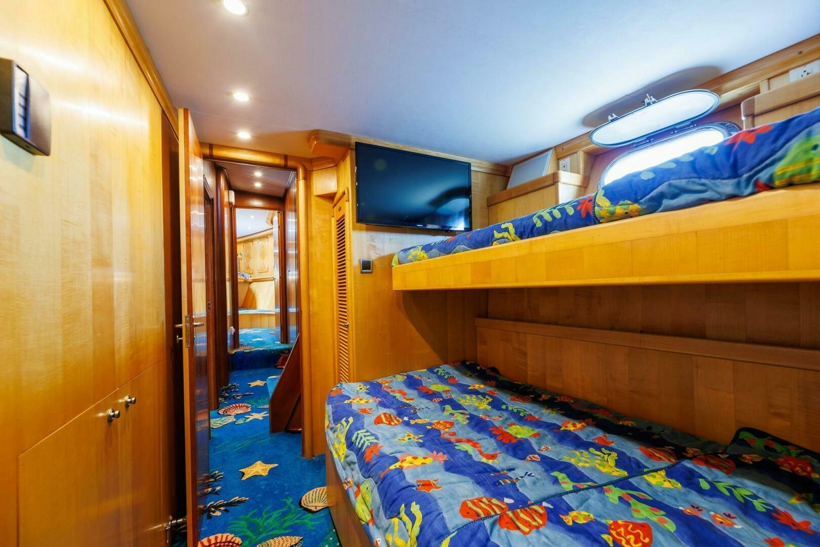 a room with a bed and a door aboard STRESS RELIEFF  Yacht for Sale