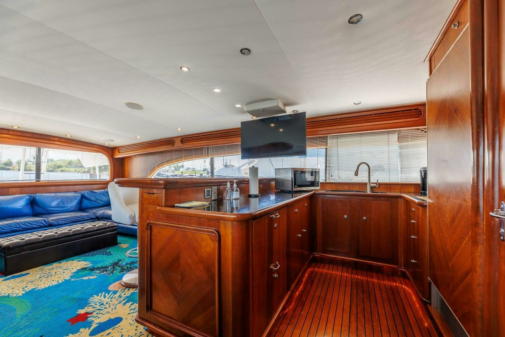 a kitchen with wooden cabinets aboard STRESS RELIEFF  Yacht for Sale