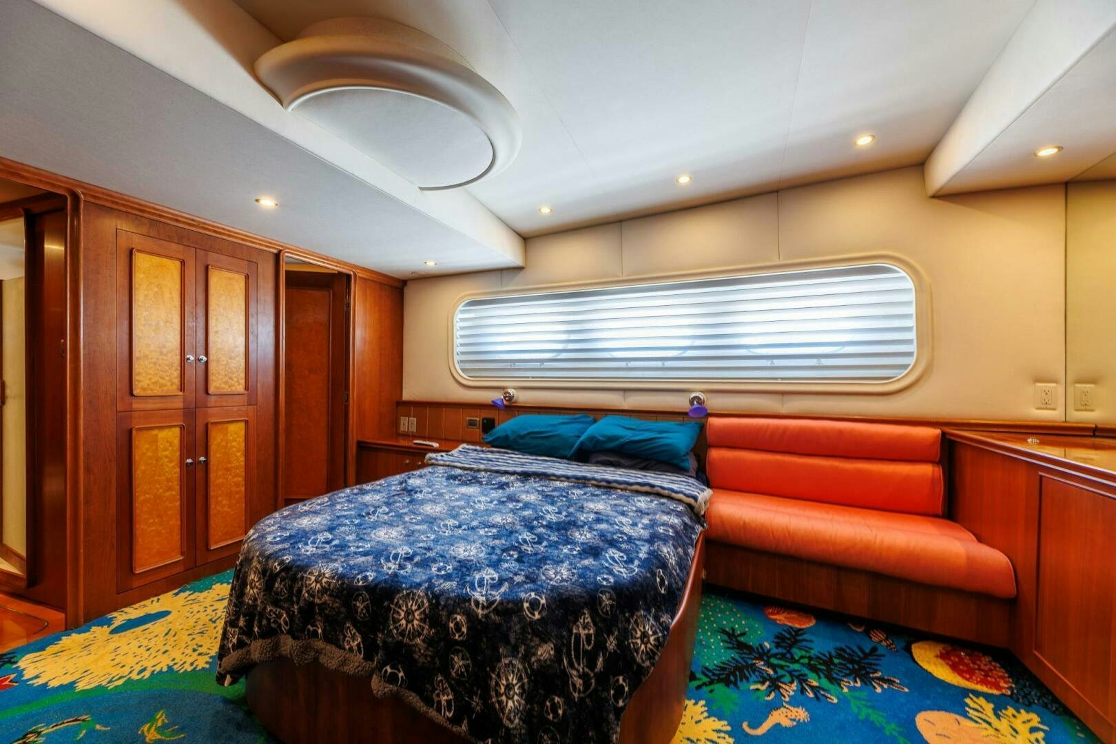a bedroom with a couch and a bed aboard STRESS RELIEFF  Yacht for Sale