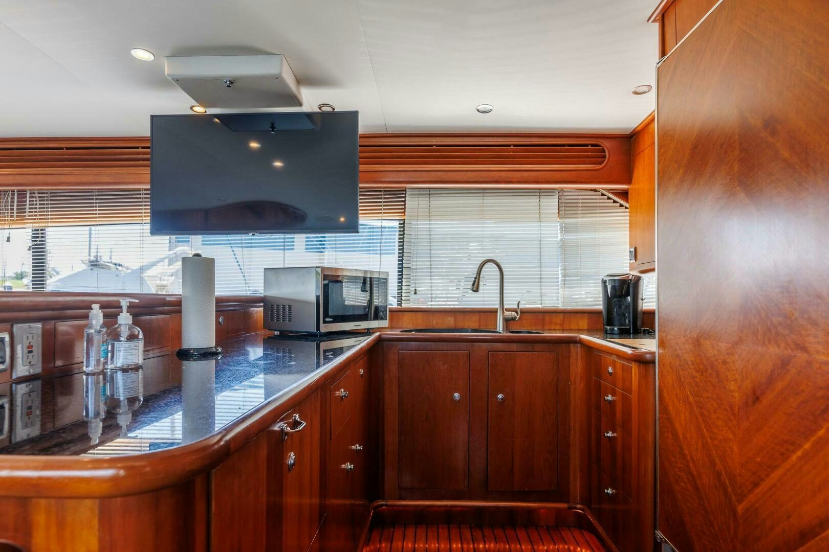 a kitchen with wooden cabinets aboard STRESS RELIEFF  Yacht for Sale