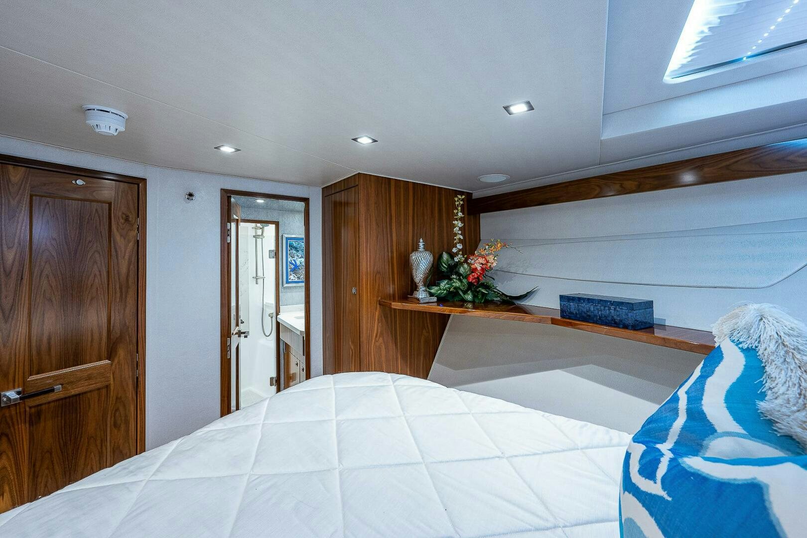 a bedroom with a bed and a desk aboard 75 TRADE Yacht for Sale