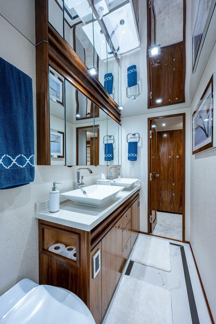 a bathroom with a sink and a mirror aboard 75 TRADE Yacht for Sale