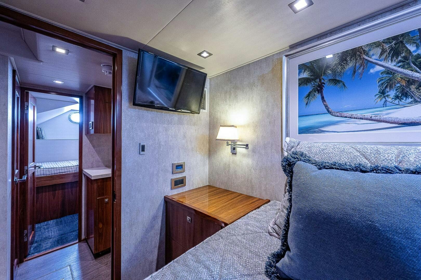 a bedroom with a bed and a television on the wall aboard 75 TRADE Yacht for Sale