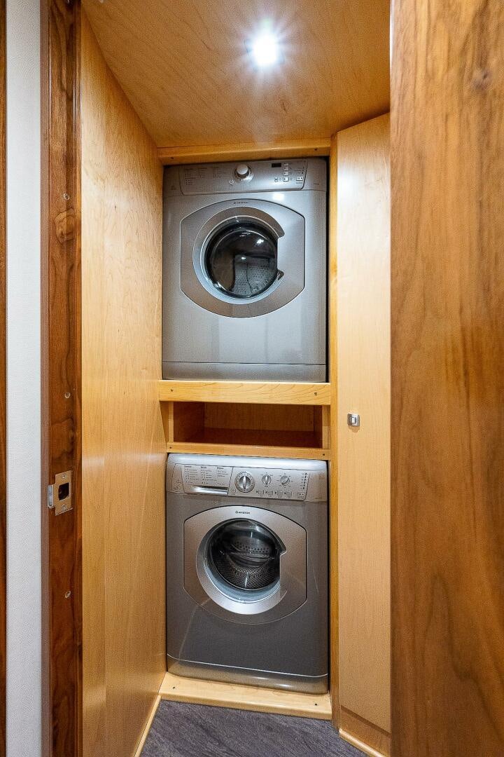 a closet with a washer and dryer aboard 75 TRADE Yacht for Sale