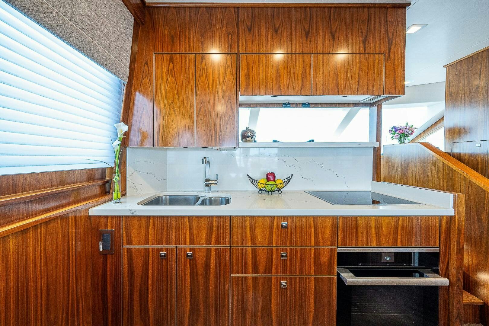 a kitchen with wooden cabinets aboard 75 TRADE Yacht for Sale