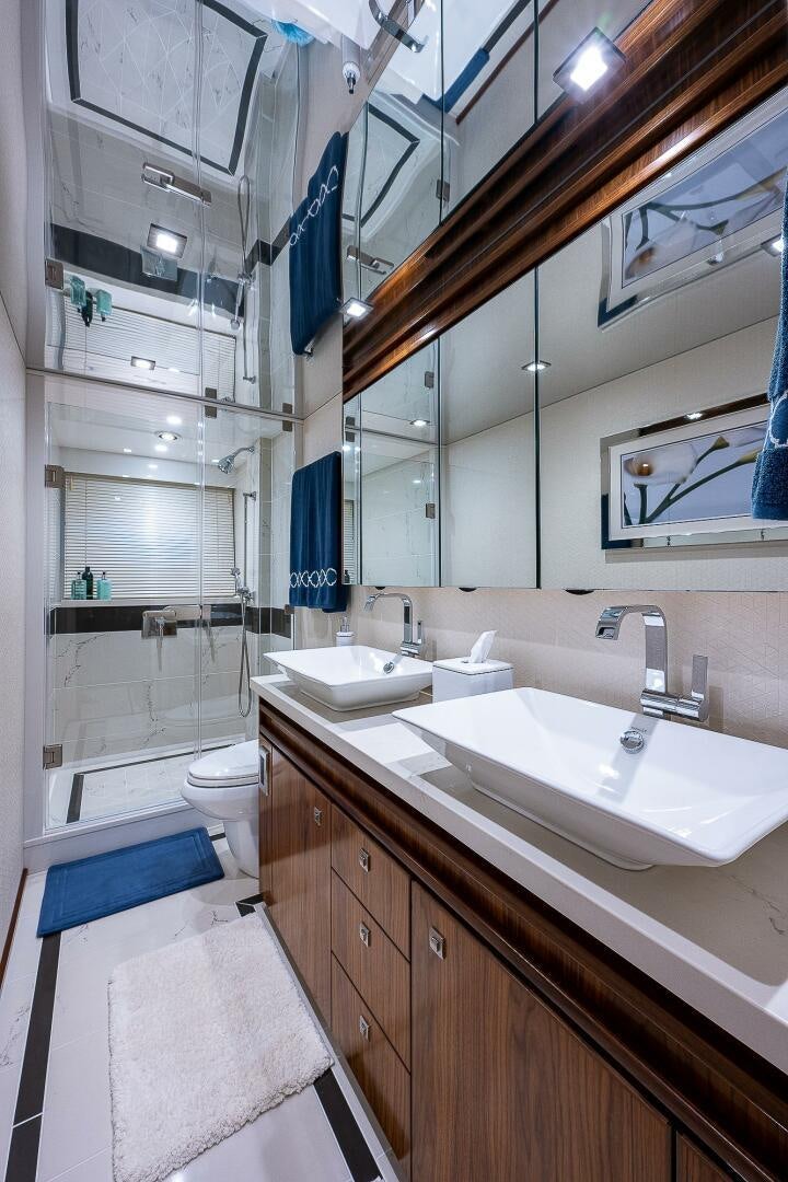 a bathroom with a sink and a mirror aboard 75 TRADE Yacht for Sale