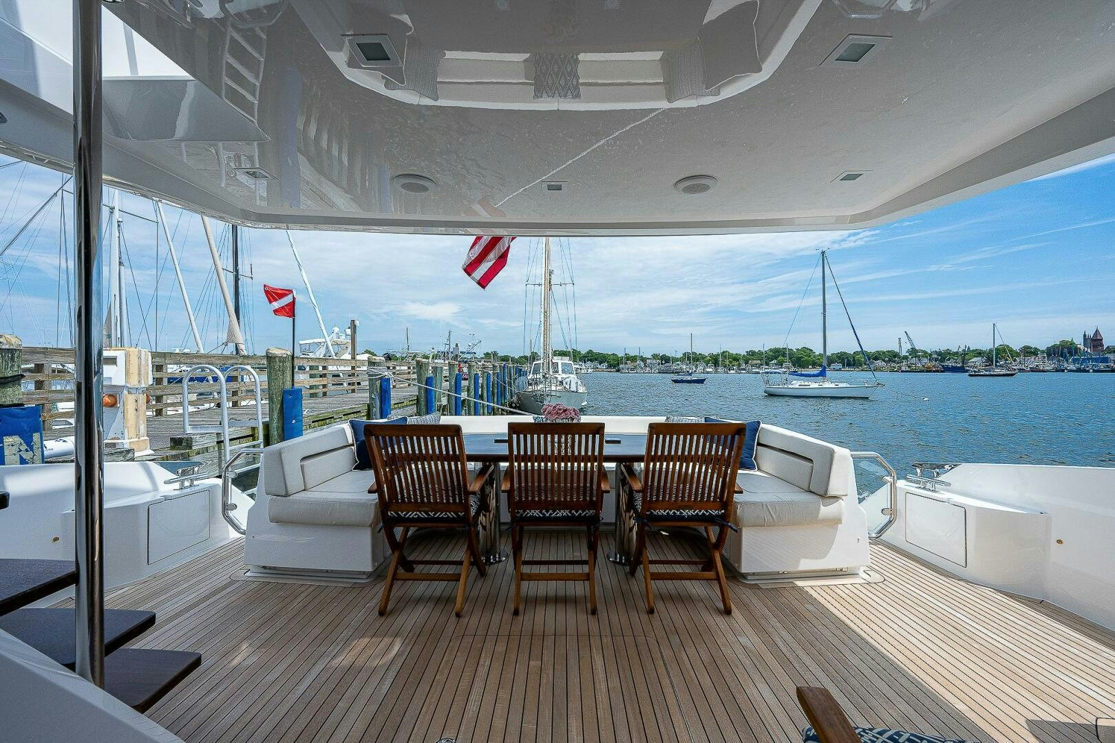 a deck with chairs and a flag on it aboard 75 TRADE Yacht for Sale