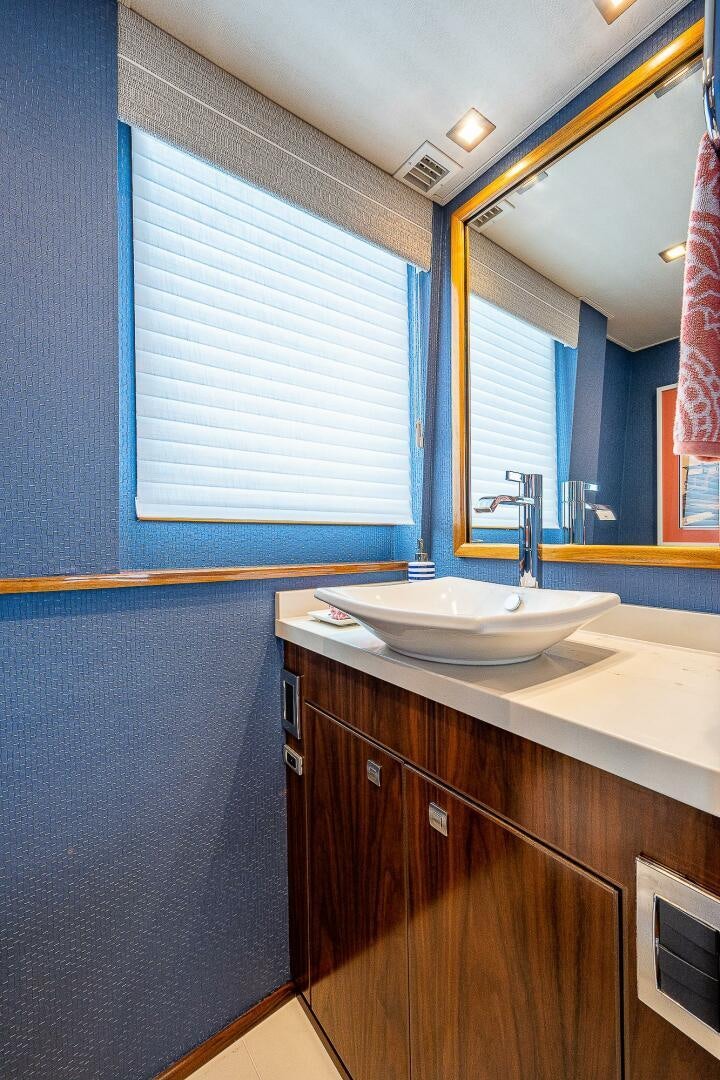 a bathroom with a sink and a mirror aboard 75 TRADE Yacht for Sale