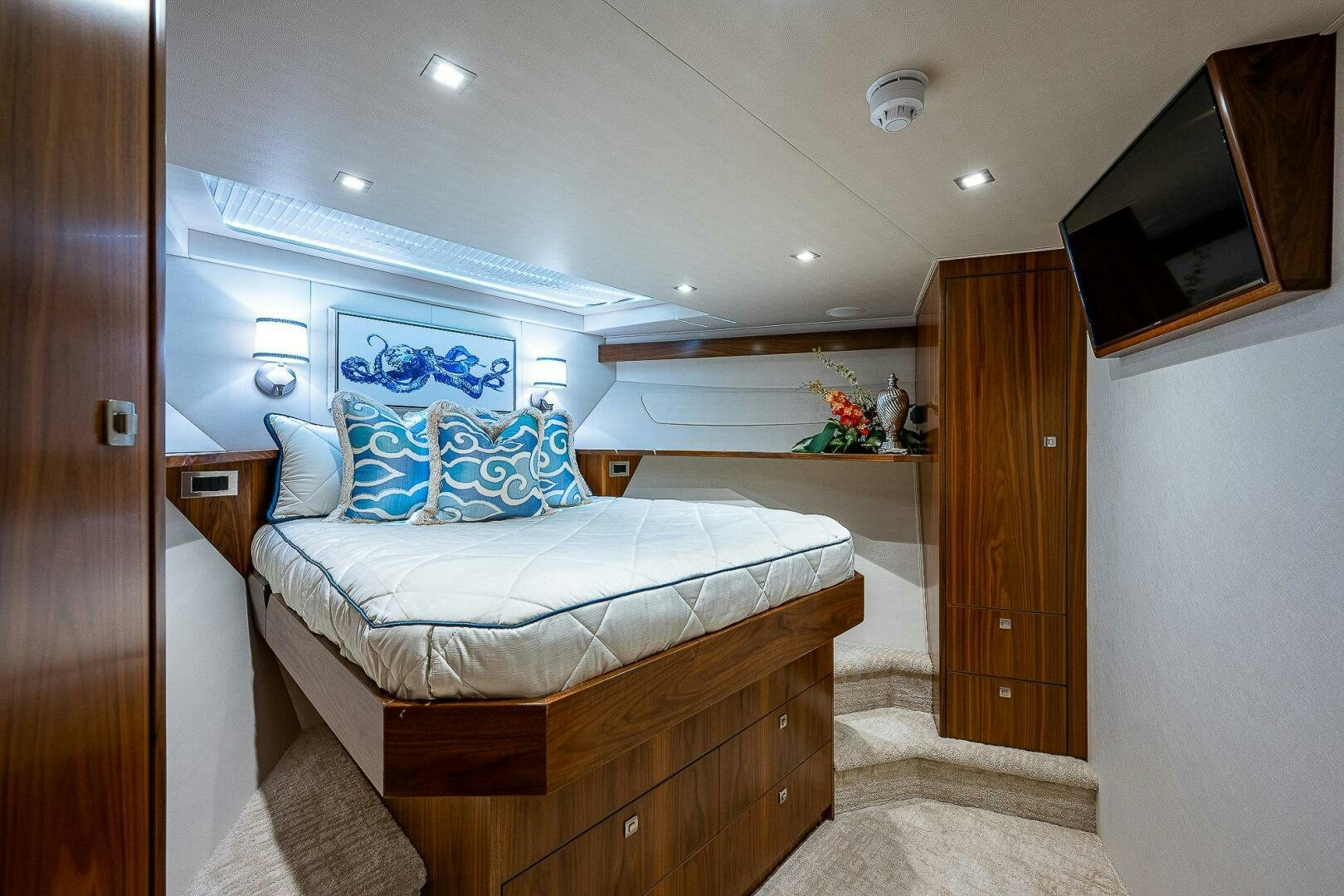a bedroom with a bed and a wood cabinet aboard 75 TRADE Yacht for Sale