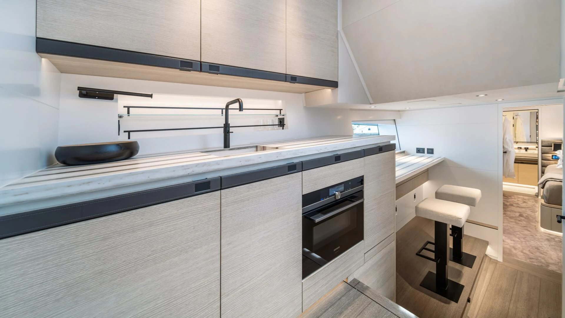 a kitchen with a stove and stools aboard FELLOWSHIP II Yacht for Sale