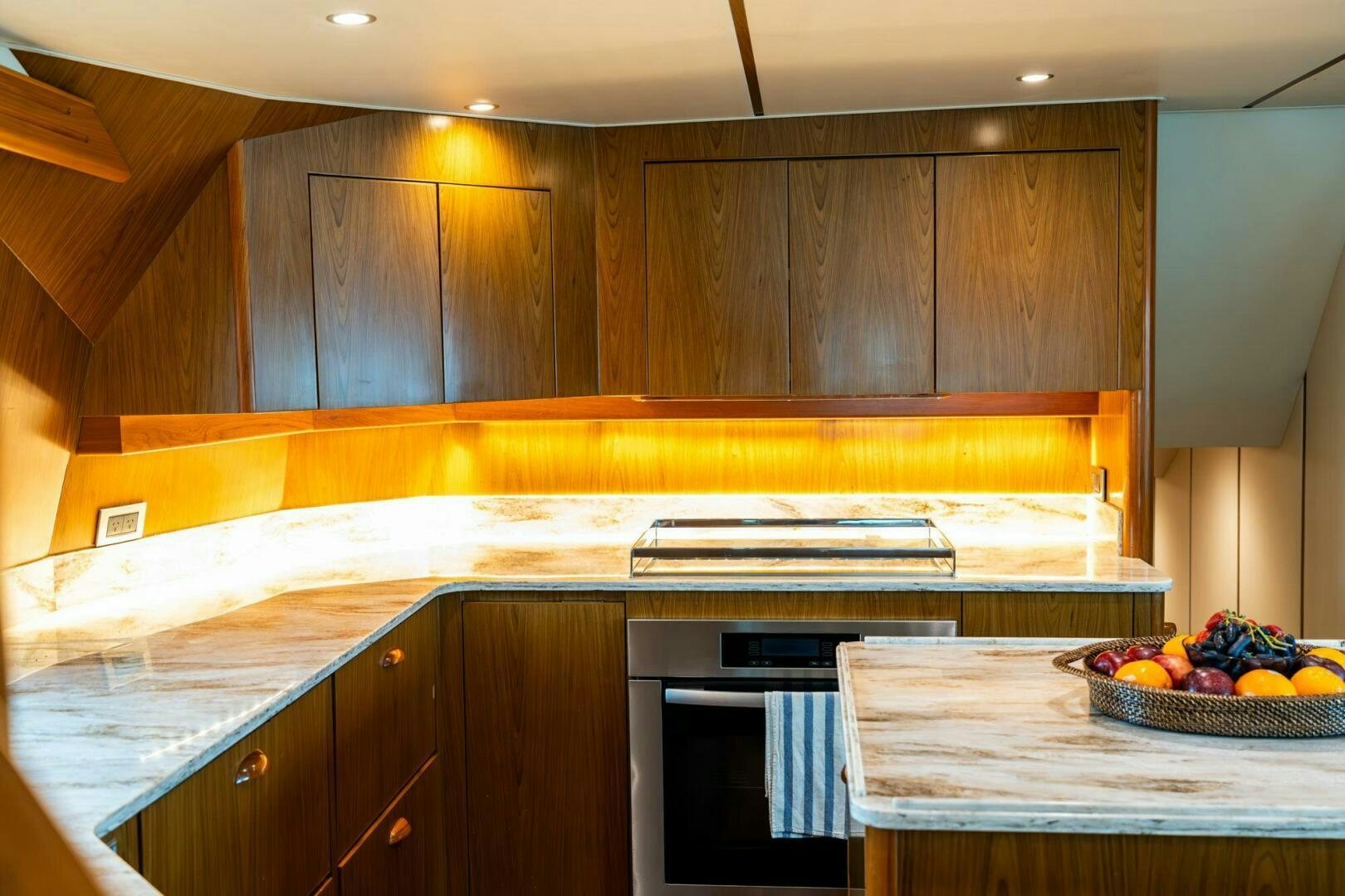 a kitchen with wooden cabinets aboard LITTLE AUDREY Yacht for Sale