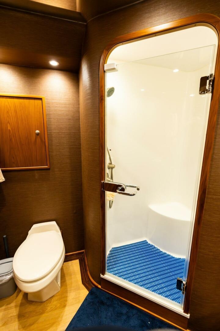 a bathroom with a toilet and a shower aboard LITTLE AUDREY Yacht for Sale