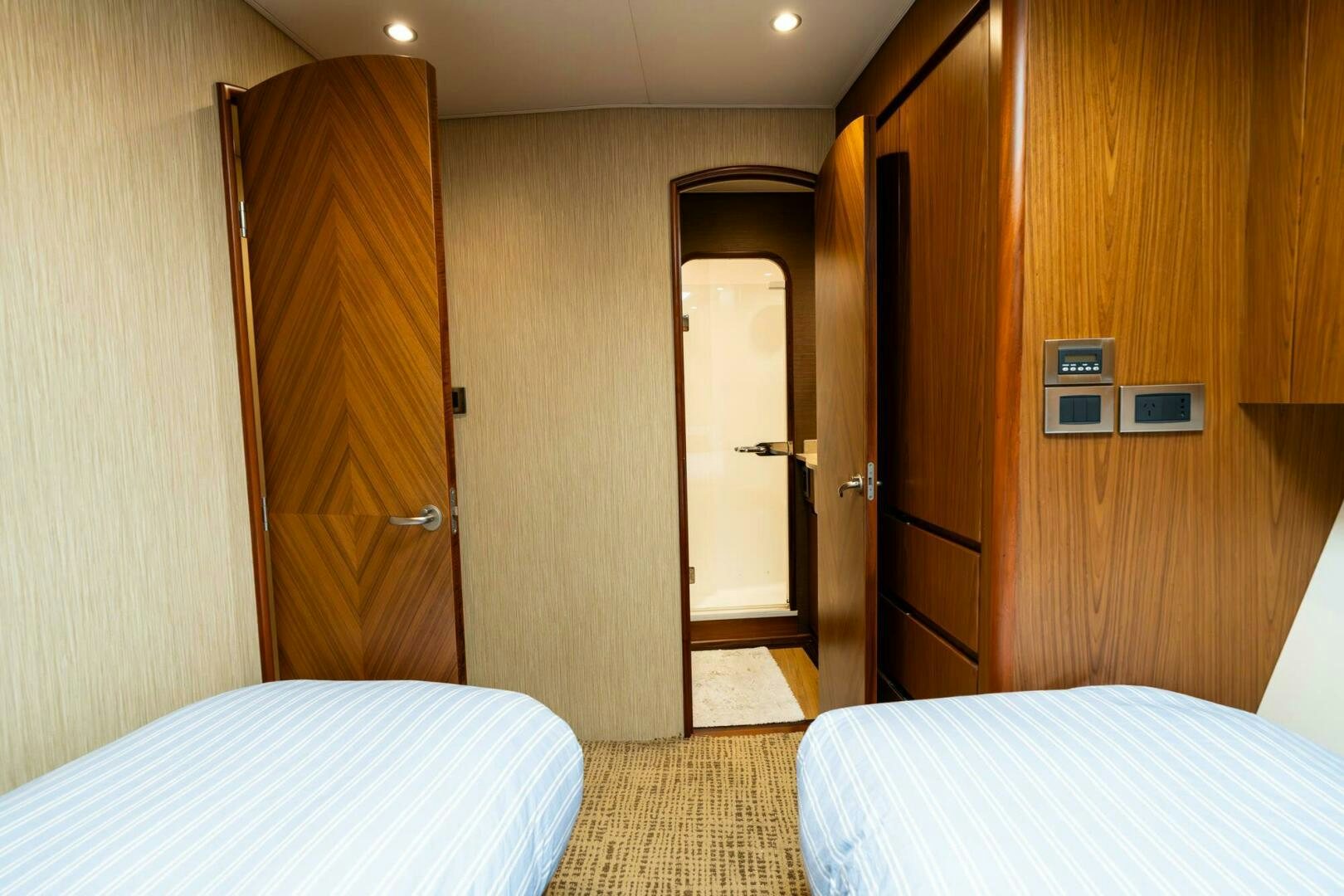 a room with a bed and a door aboard LITTLE AUDREY Yacht for Sale