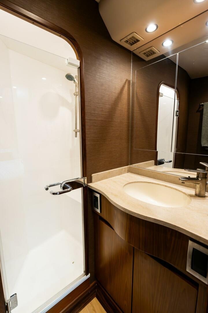 a bathroom with a sink and a mirror aboard LITTLE AUDREY Yacht for Sale