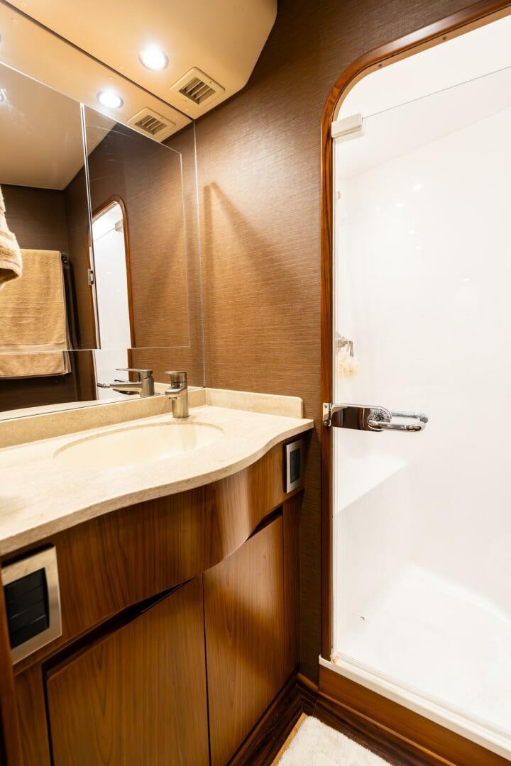 a bathroom with a sink and a mirror aboard LITTLE AUDREY Yacht for Sale