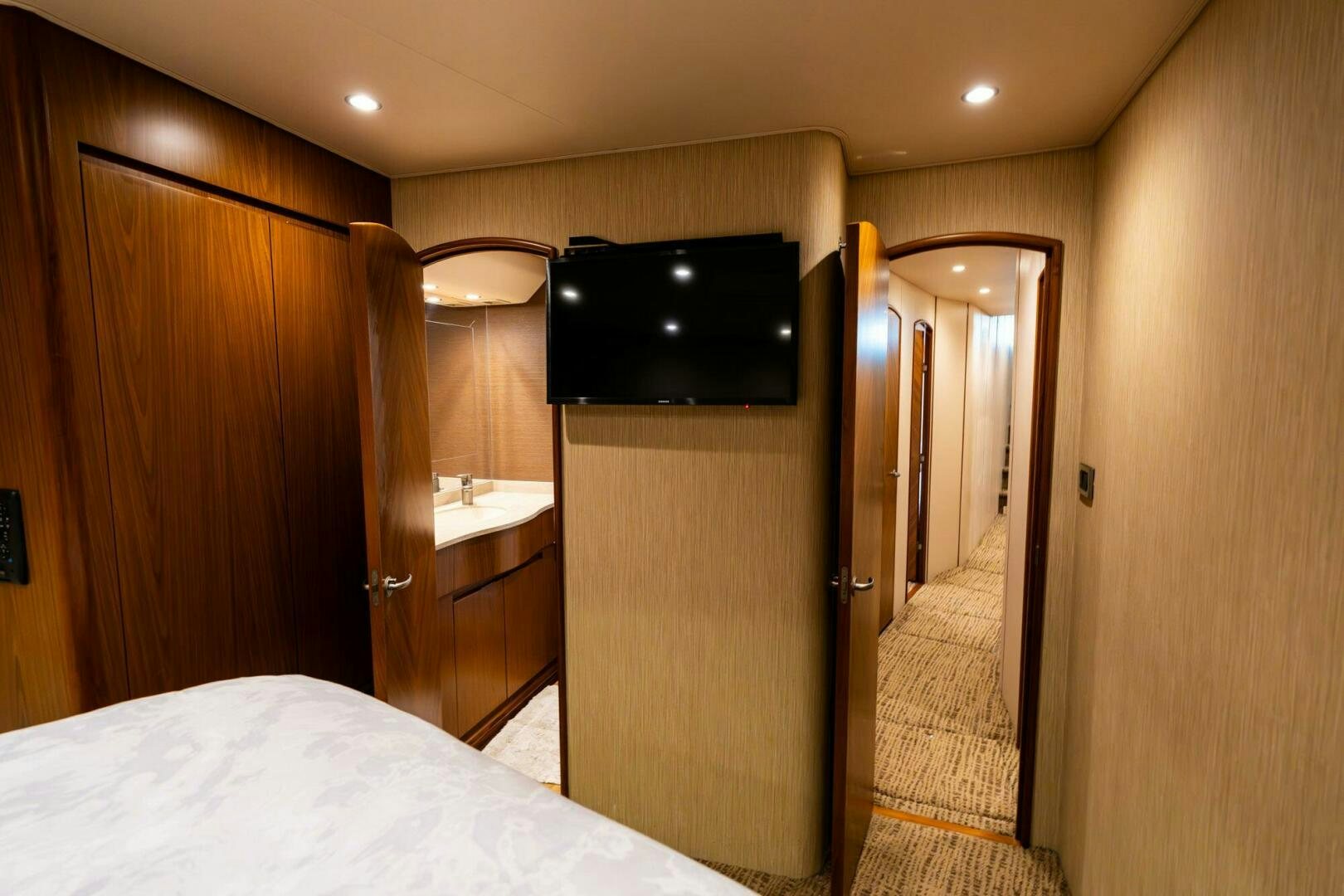 a hotel room with a bed and a television aboard LITTLE AUDREY Yacht for Sale