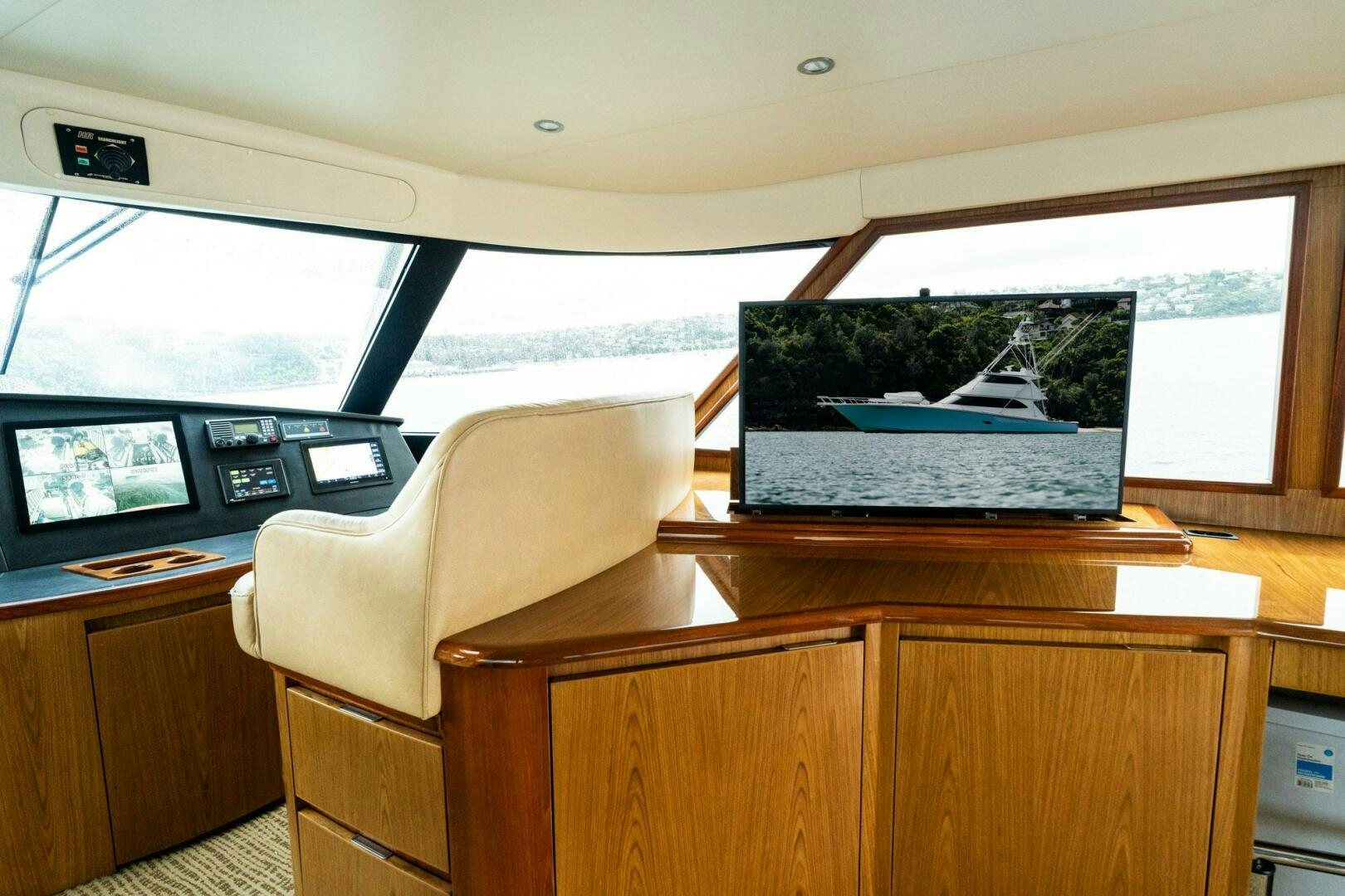 a room with a large window and a large television on the wall aboard LITTLE AUDREY Yacht for Sale