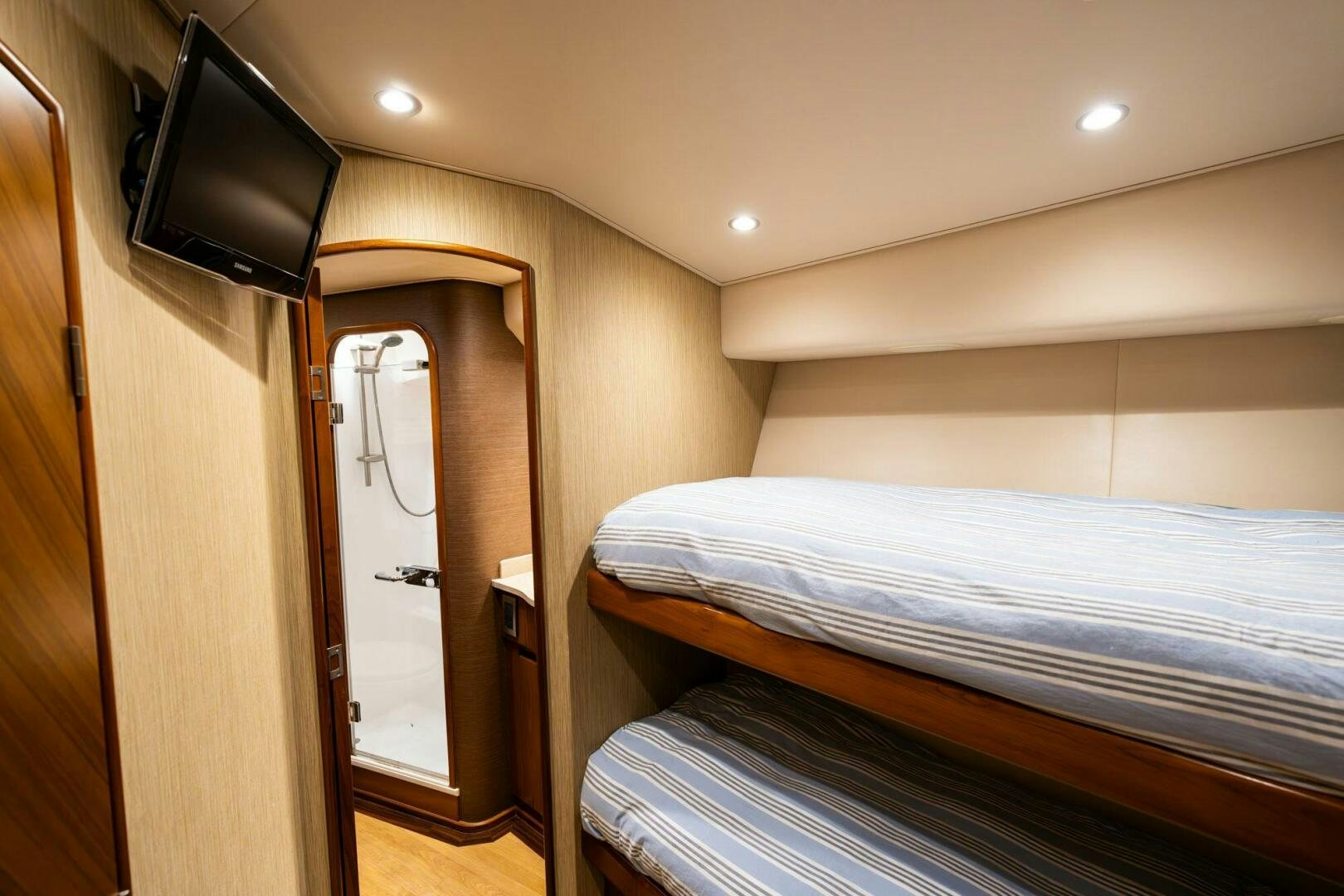 a bedroom with a bed and a television aboard LITTLE AUDREY Yacht for Sale