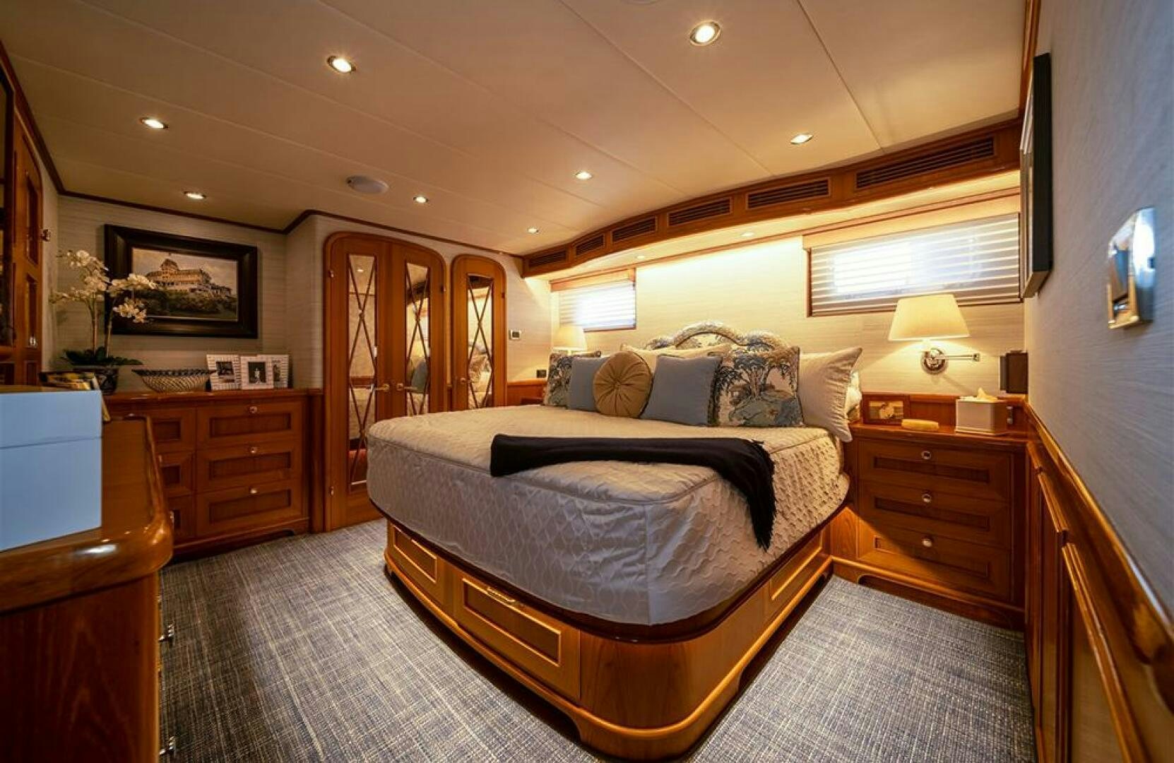 a bedroom with a bed and a dresser aboard JULIANNE Yacht for Sale