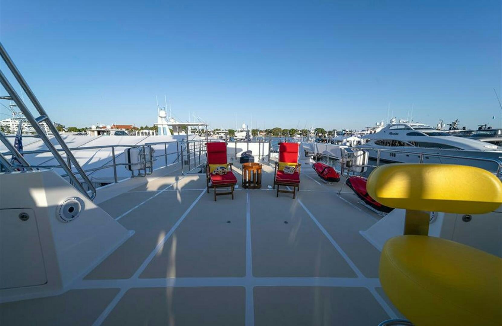 a deck with chairs and tables on it aboard JULIANNE Yacht for Sale