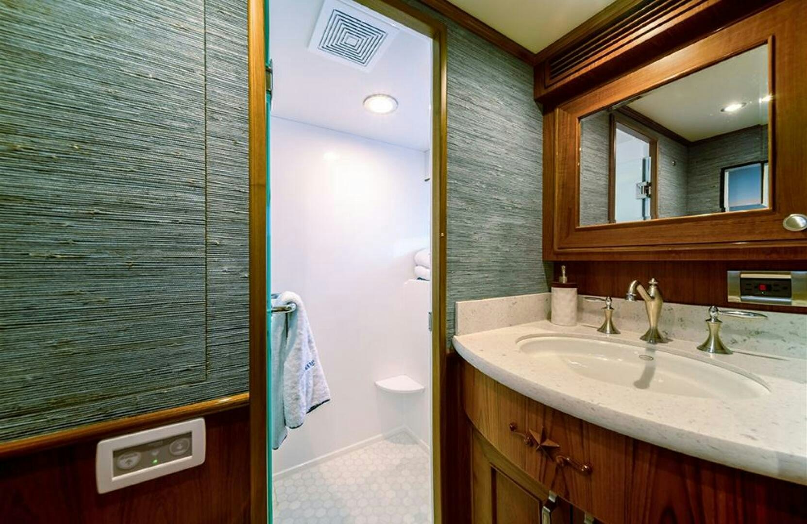 a bathroom with a sink and a mirror aboard JULIANNE Yacht for Sale