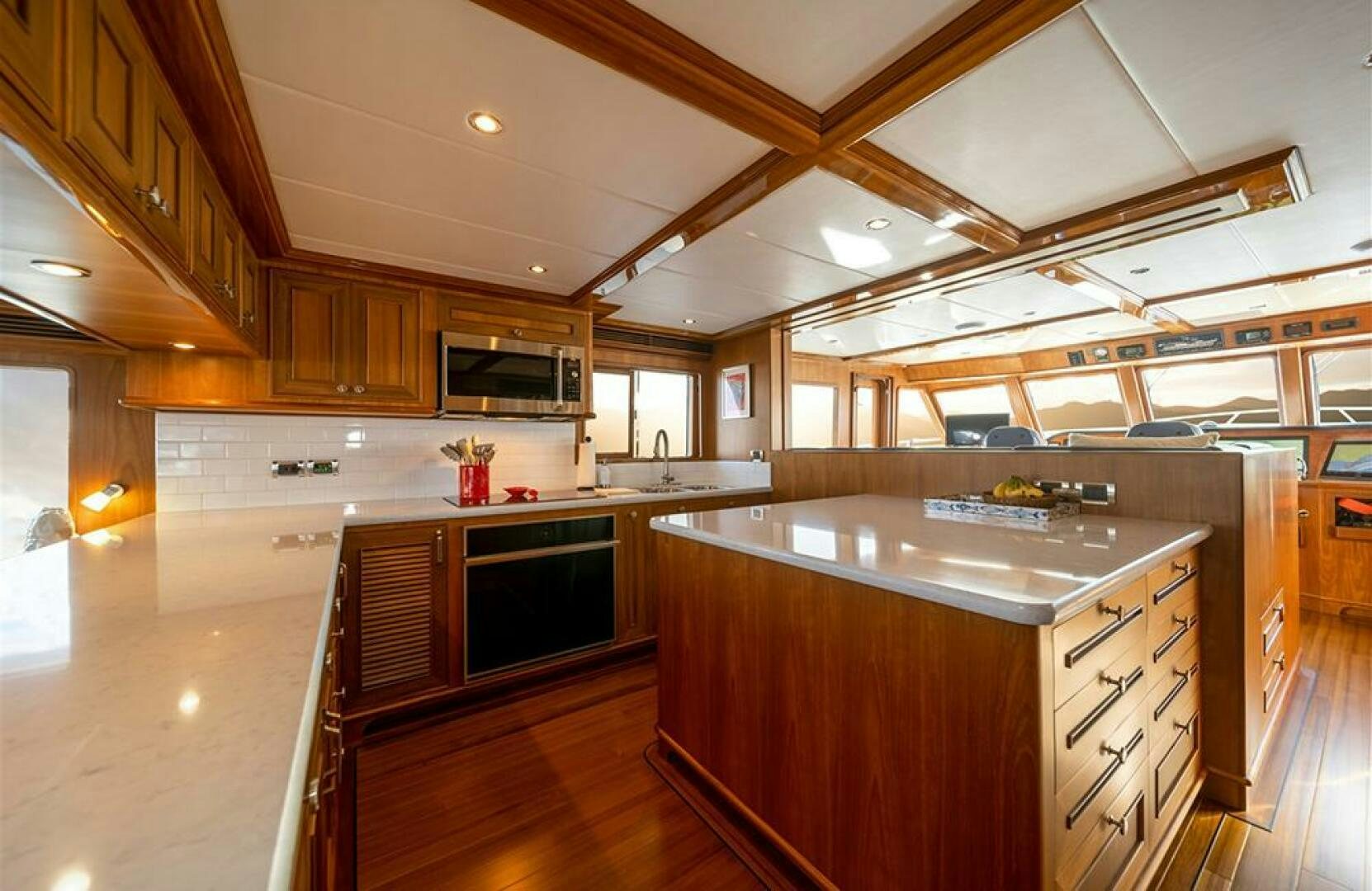 a large kitchen with wooden cabinets aboard JULIANNE Yacht for Sale
