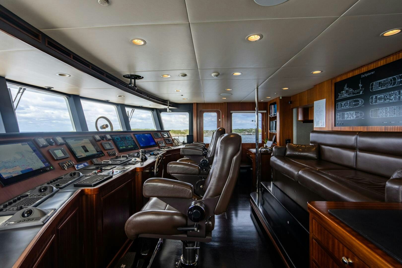 inside of a vehicle with a desk and chairs and a television aboard ZEXPLORER Yacht for Sale