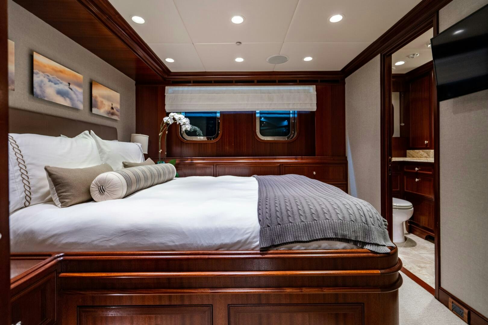 a bed with a white bed spread aboard ZEXPLORER Yacht for Sale
