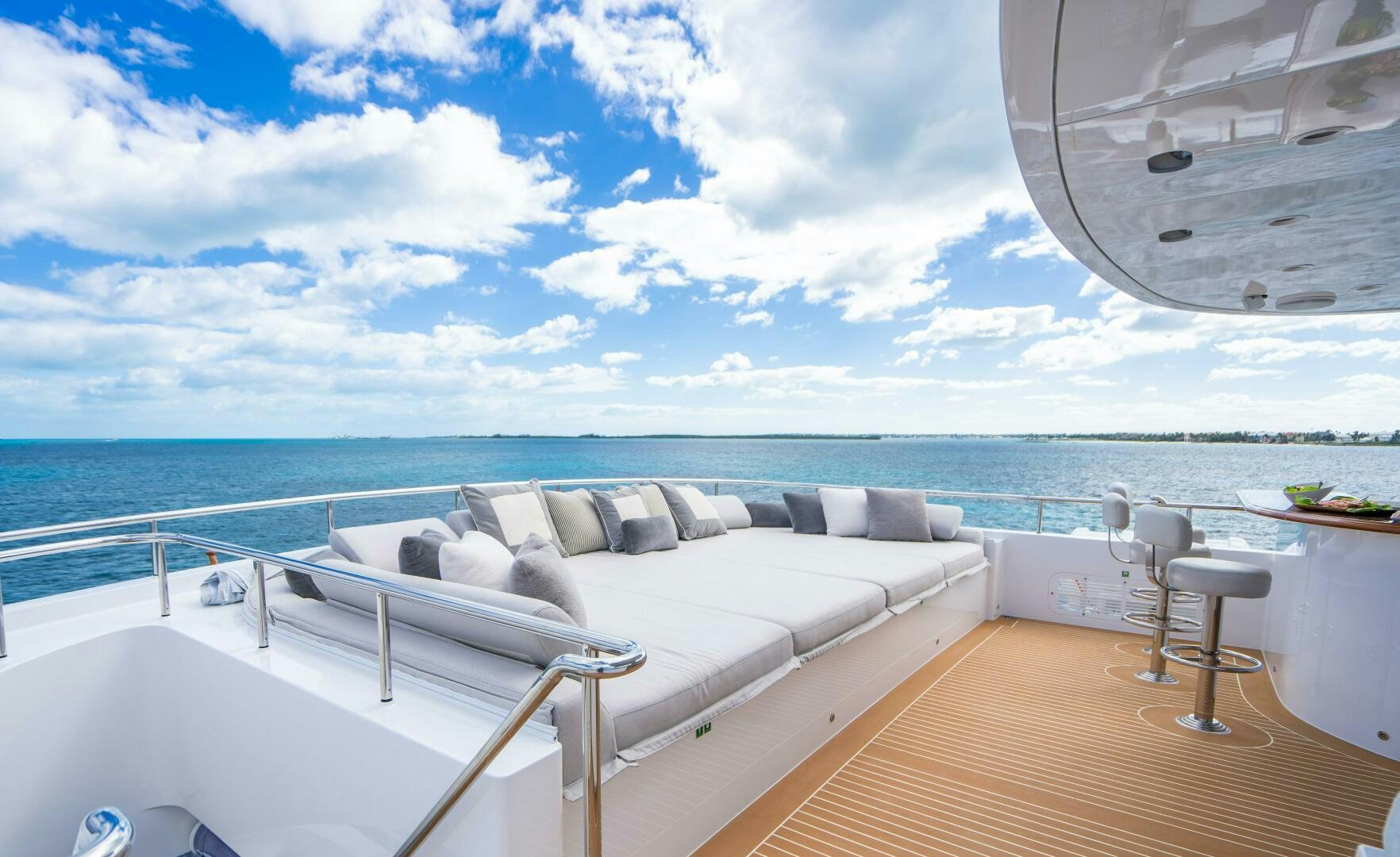 a large white bed on a deck overlooking the ocean aboard ZEXPLORER Yacht for Sale