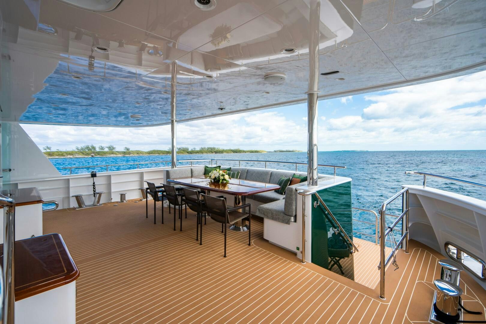 a balcony with a table and chairs aboard ZEXPLORER Yacht for Sale