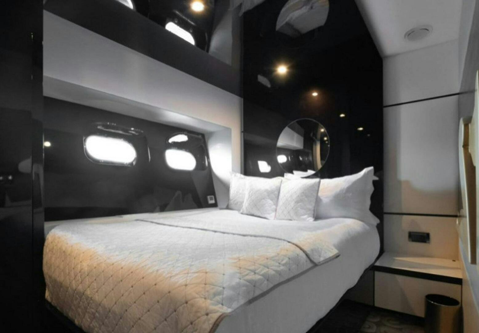 a bed with a white bed spread aboard CLAREMONT Yacht for Sale