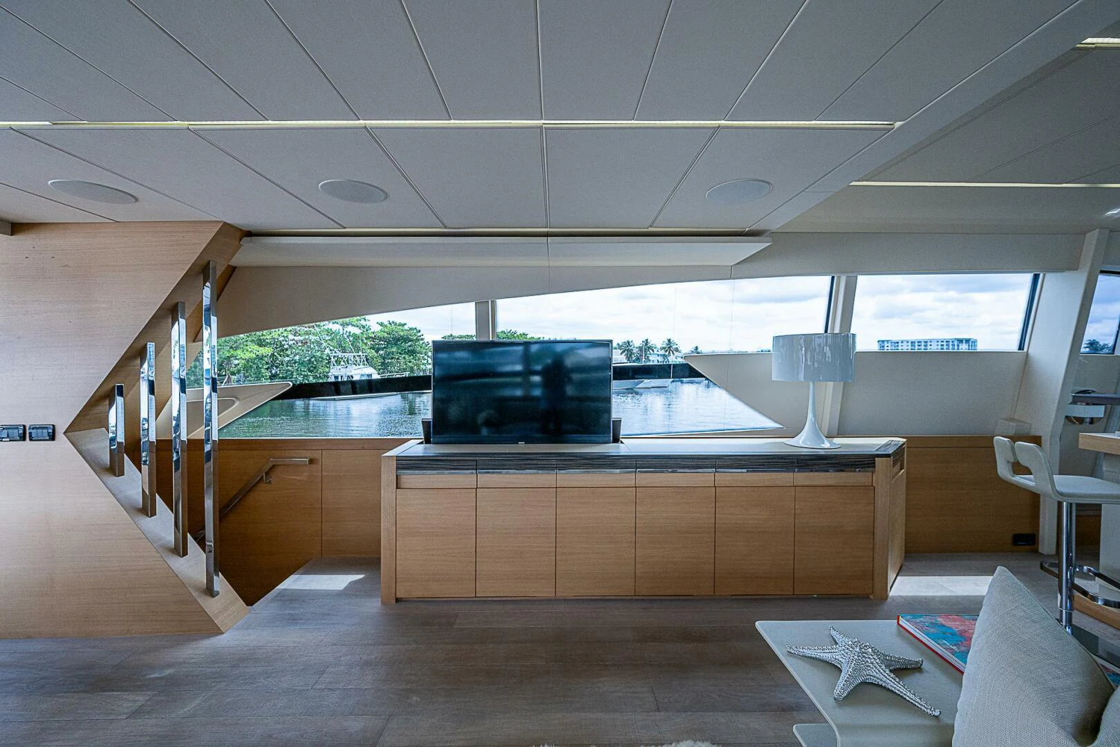 a room with a large window and a table with chairs and a large vent aboard COAL BLOODED Yacht for Sale