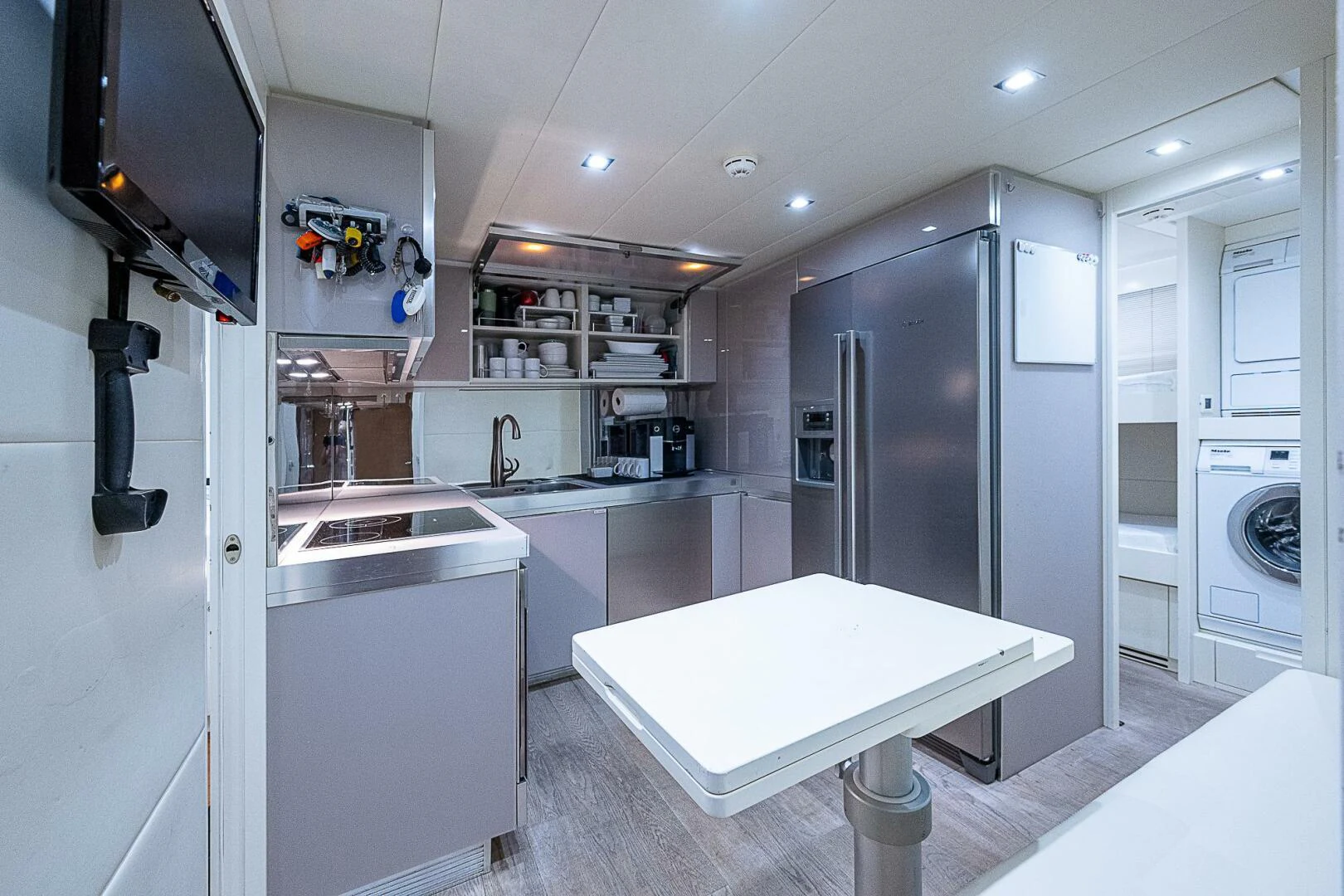 a kitchen with a large refrigerator aboard COAL BLOODED Yacht for Sale