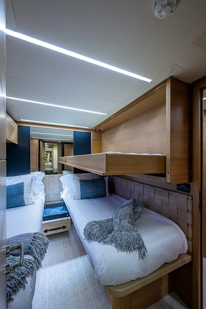 a bedroom with a bed and a mirror aboard COAL BLOODED Yacht for Sale