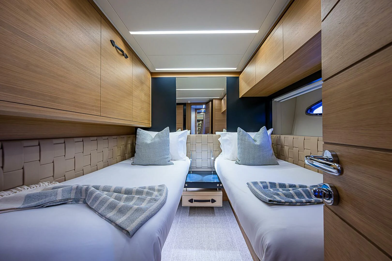 a room with beds and a wood cabinet aboard COAL BLOODED Yacht for Sale