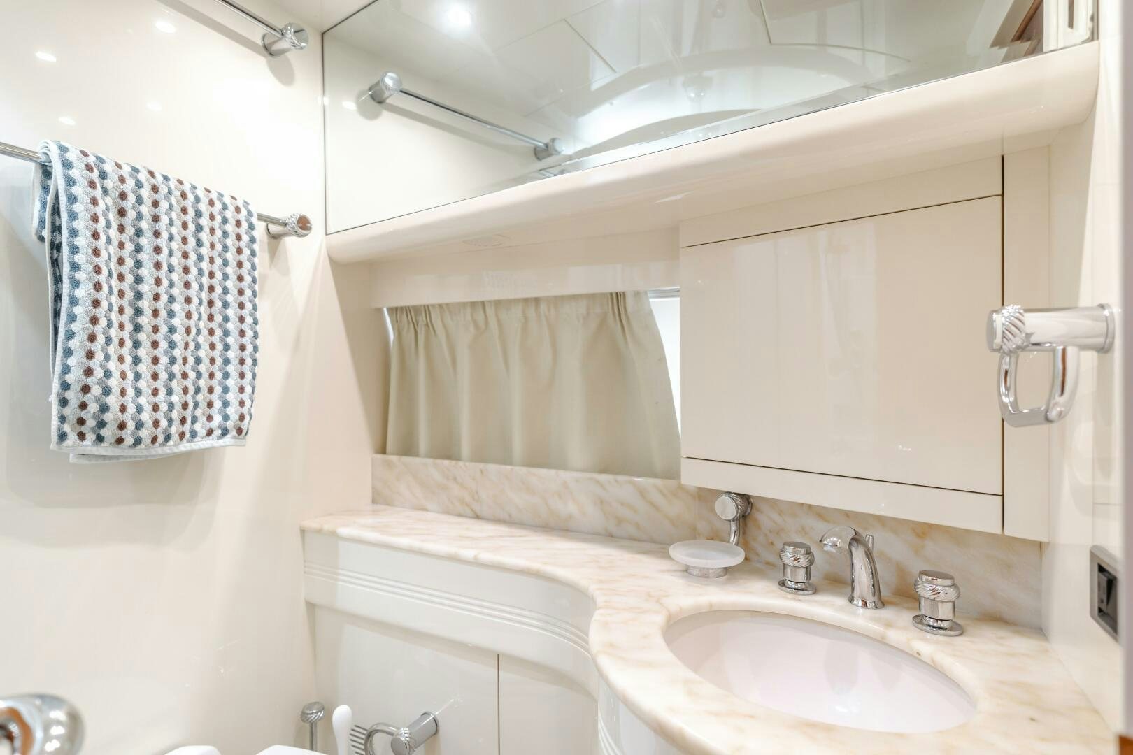 a bathroom with a sink and a mirror aboard ANEJO Yacht for Sale