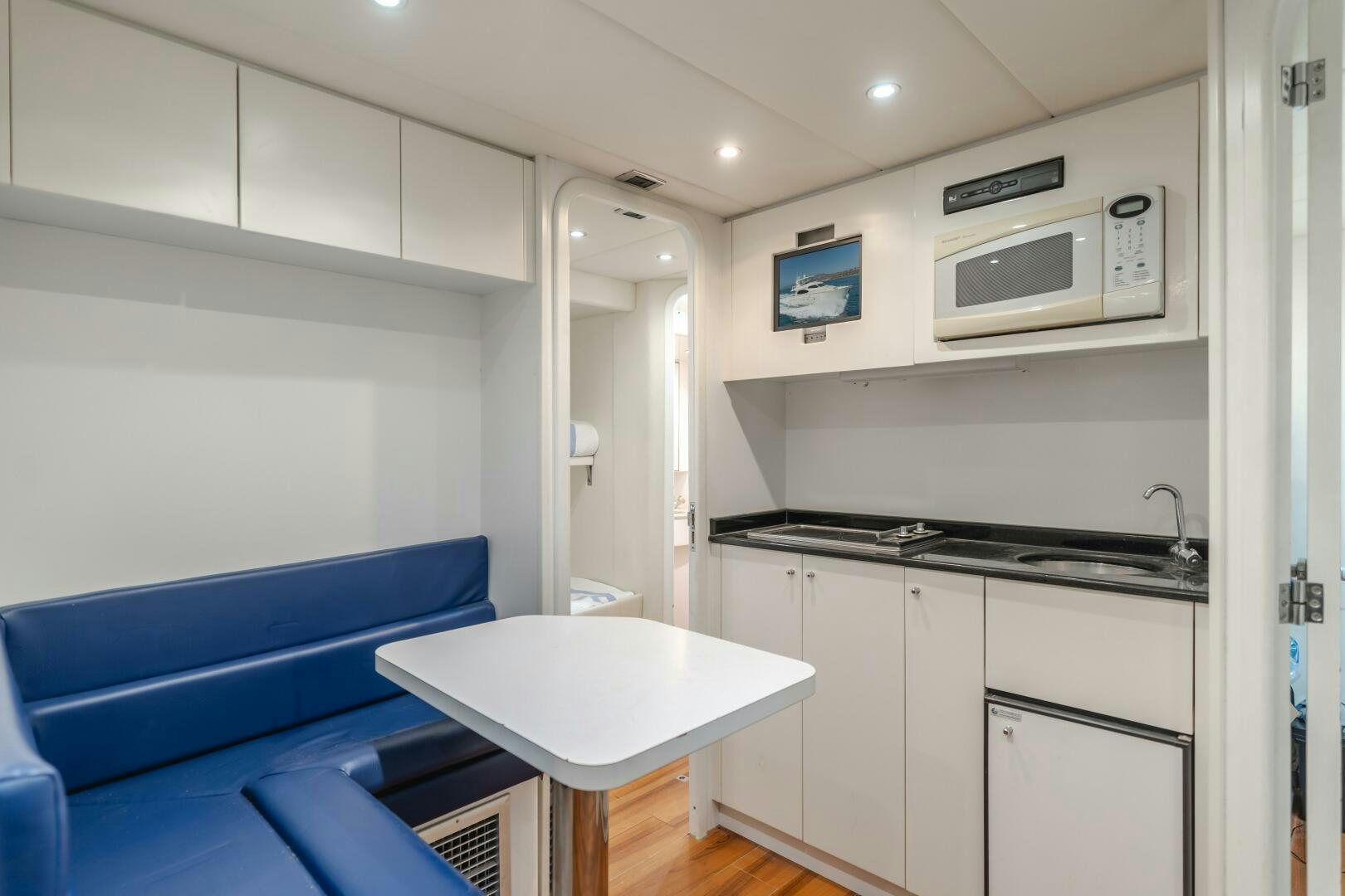 a room with a desk and a microwave aboard ANEJO Yacht for Sale