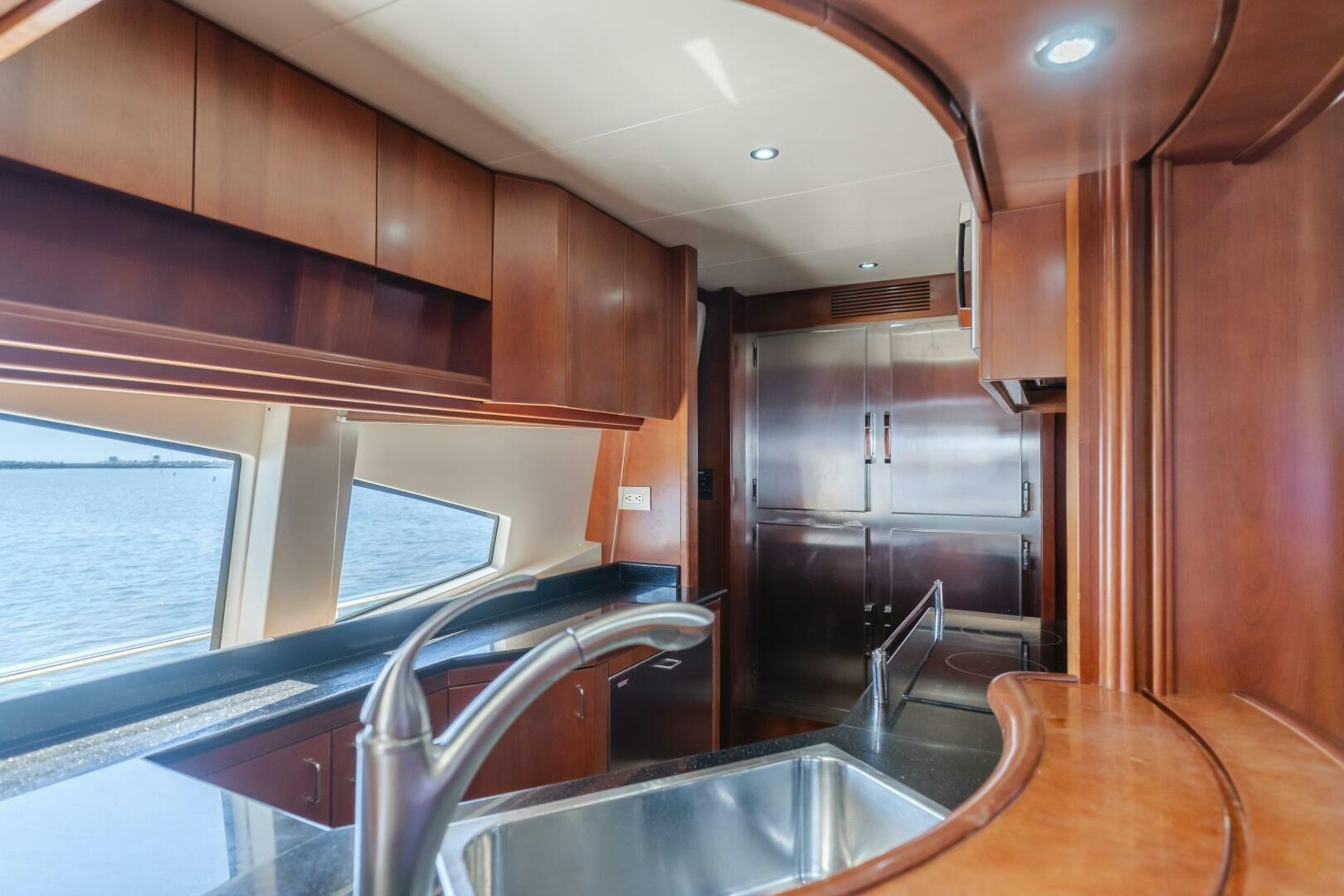 a kitchen with wooden cabinets aboard ANEJO Yacht for Sale