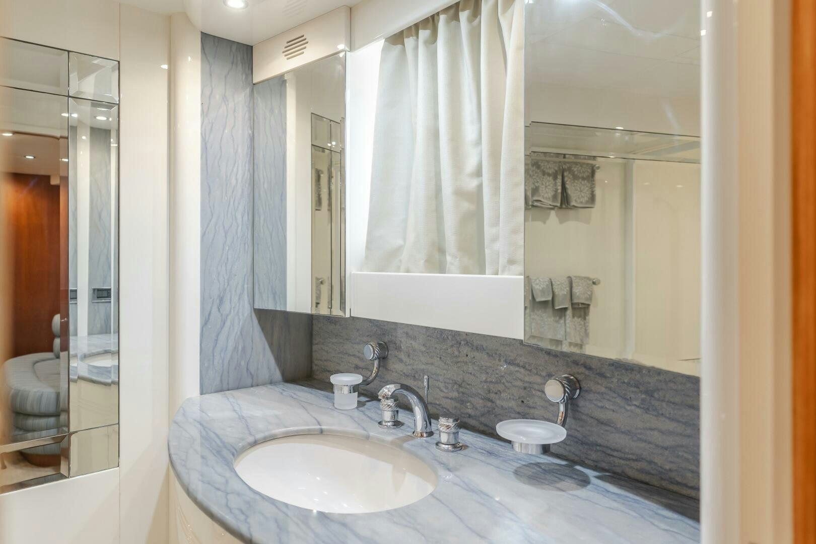 a bathroom with a countertop sink and mirror aboard ANEJO Yacht for Sale