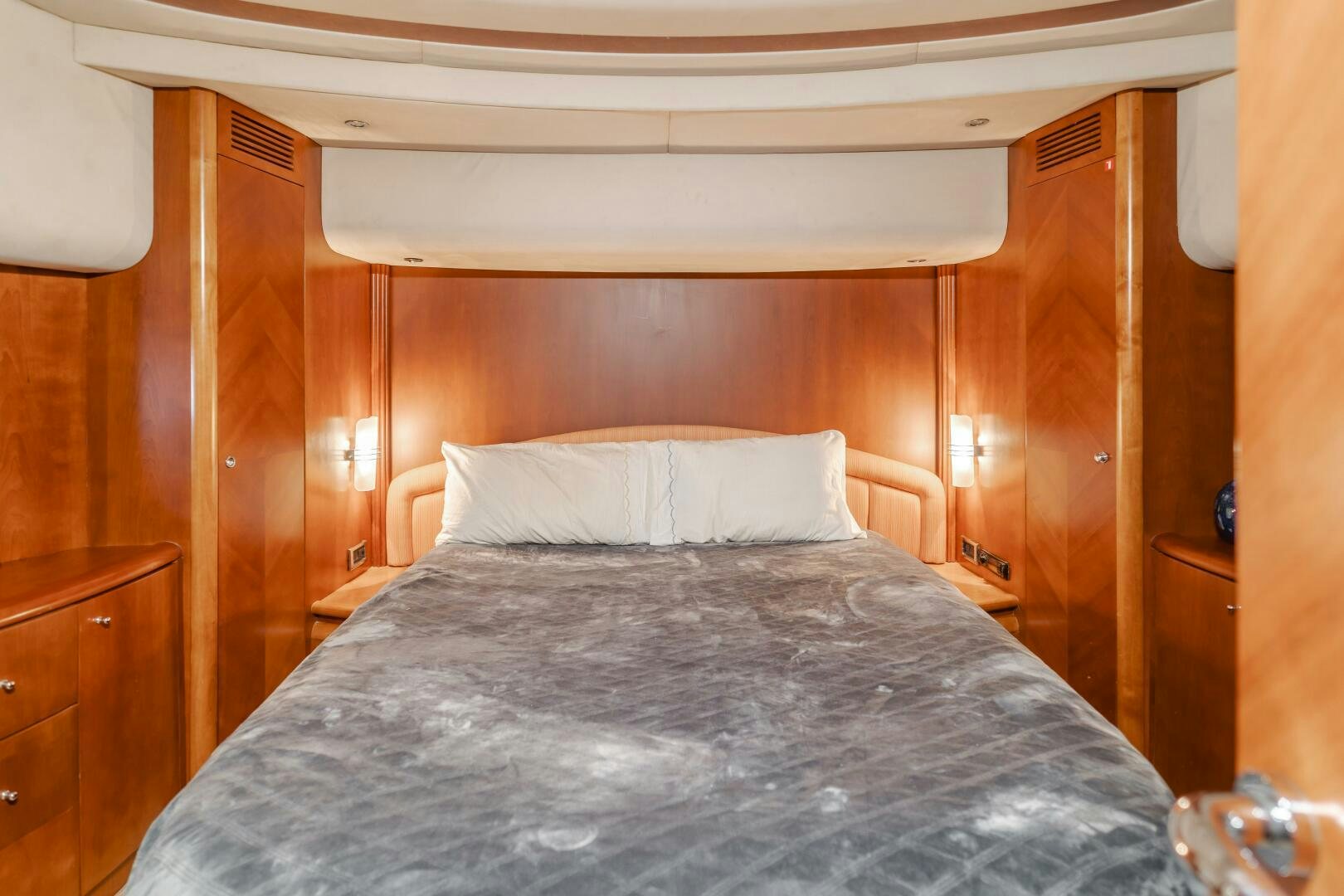 a bed with a white pillow aboard ANEJO Yacht for Sale