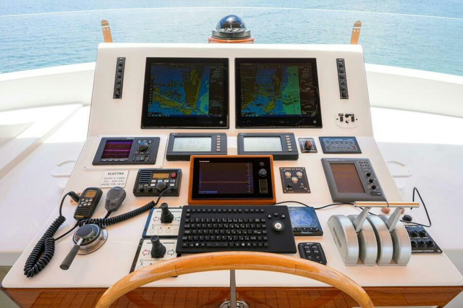 a laptop with a keyboard and headphones on it aboard ELECTRA Yacht for Sale