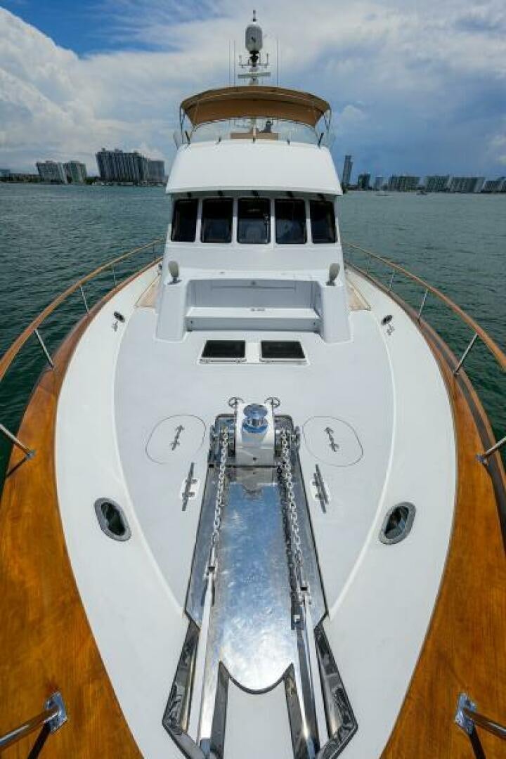 a white boat on a body of water aboard ELECTRA Yacht for Sale
