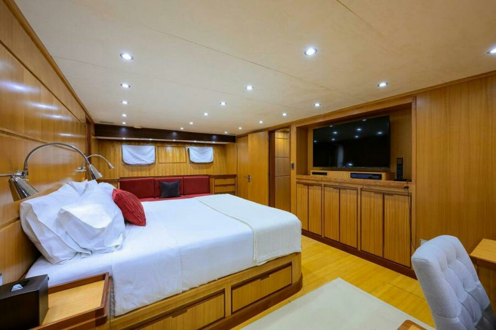 a bedroom with a bed and a tv aboard ELECTRA Yacht for Sale