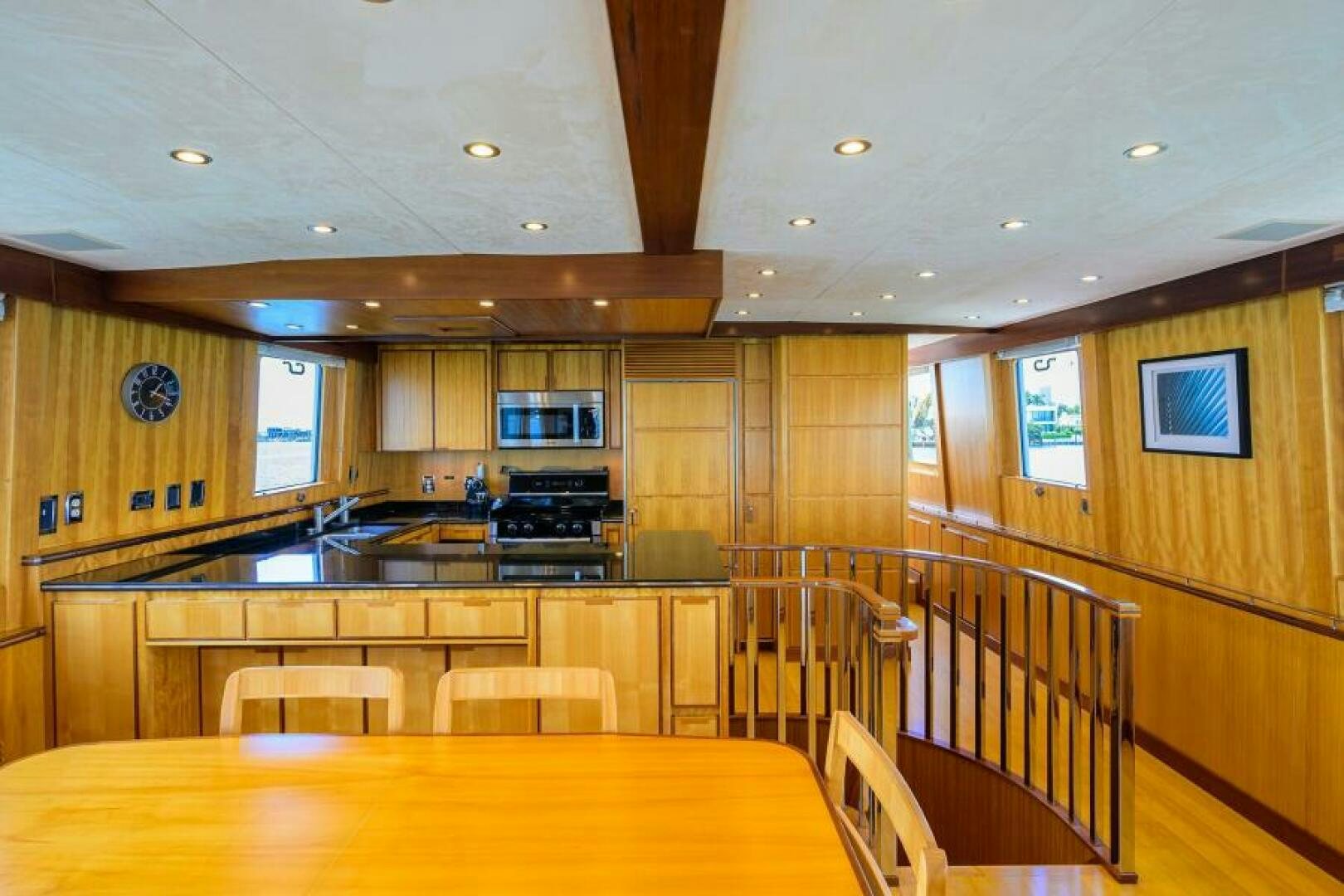 a kitchen with wooden cabinets aboard ELECTRA Yacht for Sale