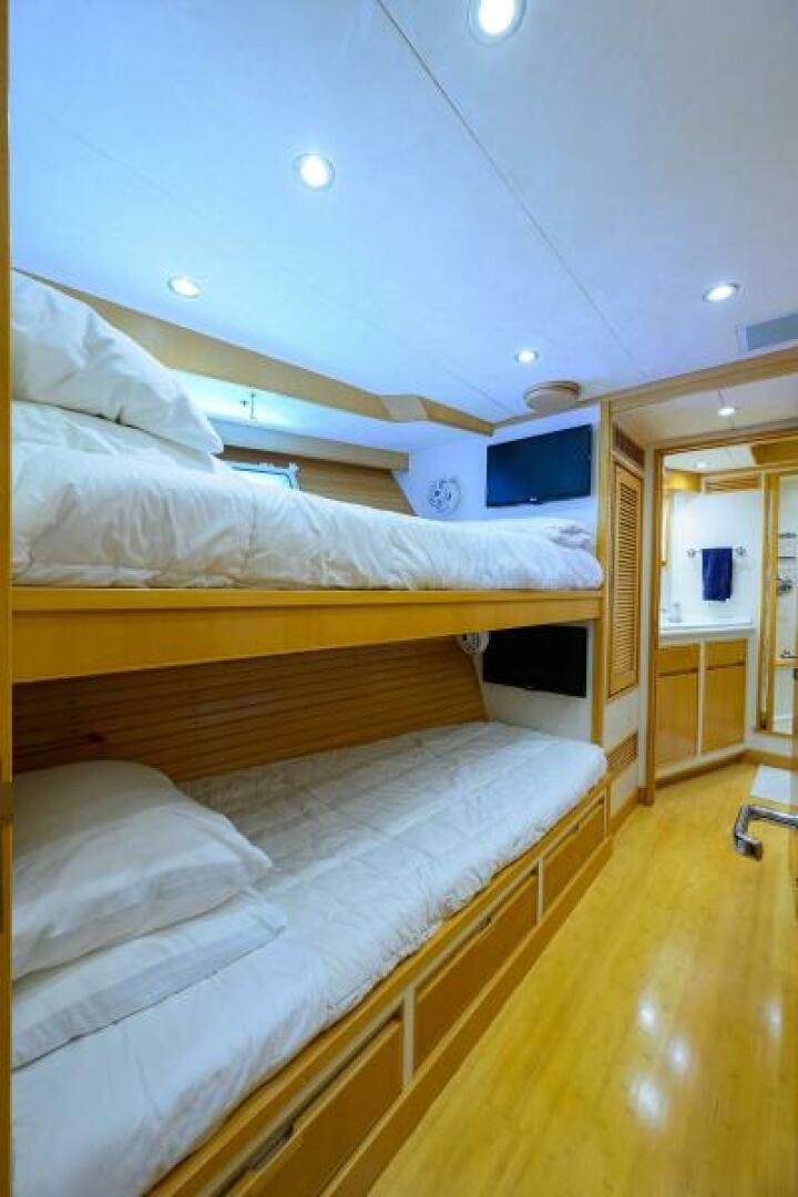 a room with a bed and a closet aboard ELECTRA Yacht for Sale
