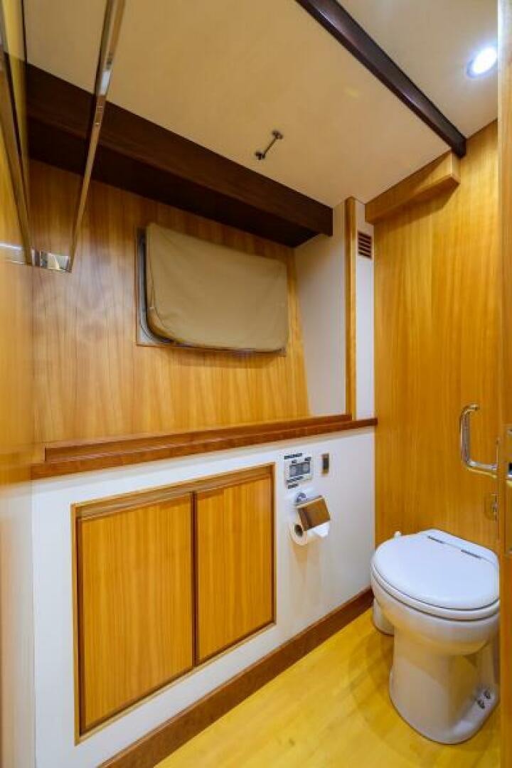a bathroom with wooden cabinets aboard ELECTRA Yacht for Sale