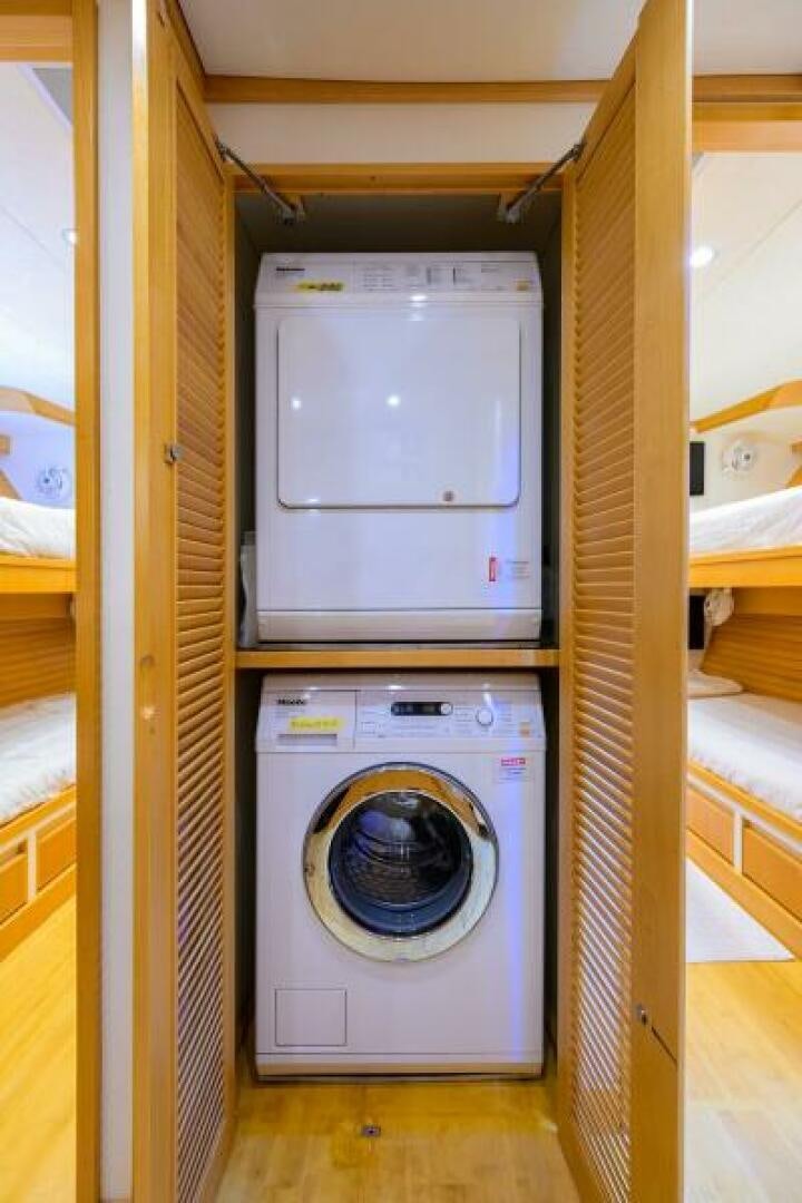 a washing machine in a room aboard ELECTRA Yacht for Sale