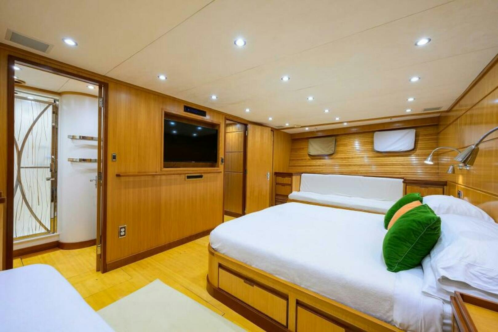 a room with a bed and a television aboard ELECTRA Yacht for Sale